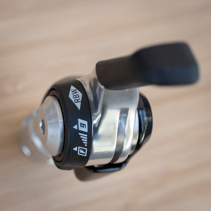 Use a 4mm hex to loosen the tension bolt enough to flip the red mark to F for friction. Then resnug the bolt. Mildly snug is sufficient.